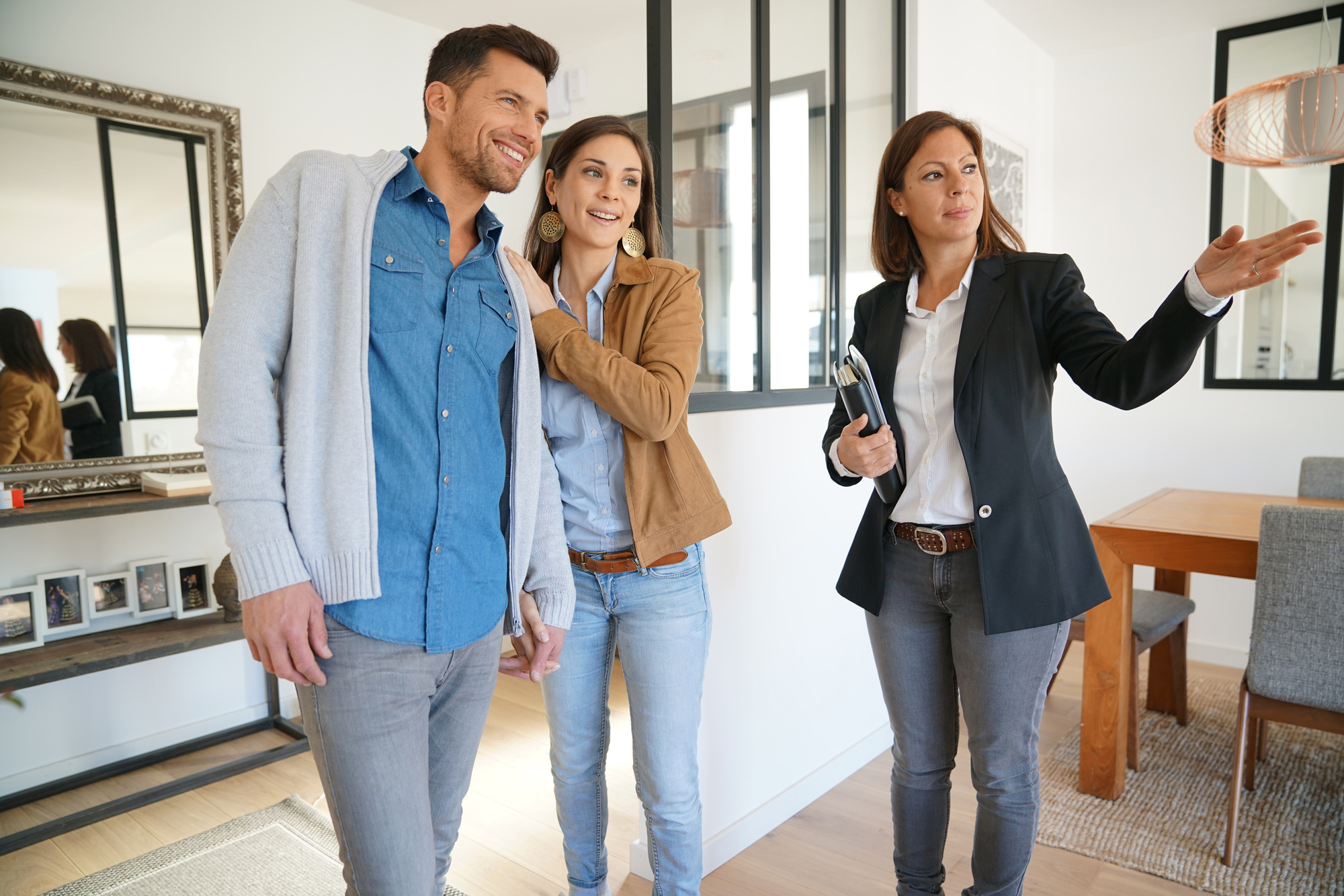 Couple with real-estate agent visiting house for sale